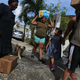 Residents carry food and water provided by FEMA on Oct. 17, 2017, in San Isidro, Puerto Rico. (Mario Tama/Getty Images)